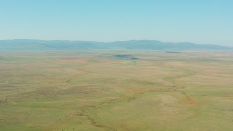 Grassland-pastures-in-Serbian-highlands,-high-aerial-view-over-prairie-plains