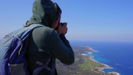 A-hiker-takes-photos-from-the-peak-of-a-mountain,-Moutti-tis-Sotiras,-Akamas-Cyprus