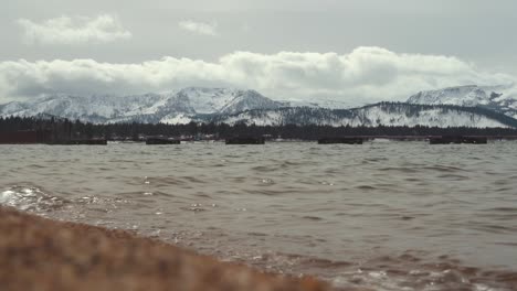 Lake-Tahoe-surrounded-by-the-Sierra-Nevada-Mountains-covered-in-snow-landscape-and-dramatic-clouds-and-light