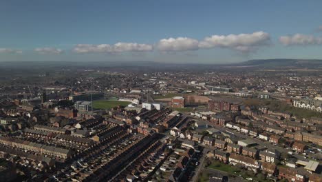 4K-aerial-view-of-taunton-Somerset,-United-Kingdom,-drone-moving-back-and-showing-the-blue-sky-with-some-clouds