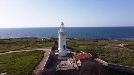 Drone-shot-flying-towards-a-beautiful-lighthouse-on-the-coast-on-Cyprus,-Greece