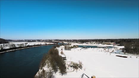 Flying-along-the-river-bank-of-the-Cumberland-River-in-Clarksville,-Tennessee,-after-a-snowstorm