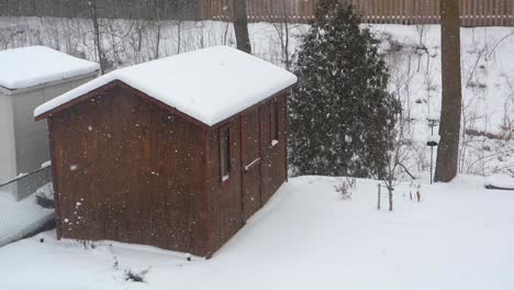 Gentle-Winter-Snowfall-Over-Wooden-Shed,-120-fps-Slow-Motion