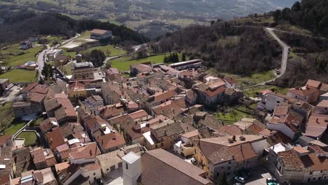 Aerial-landscape-view-of-Pietraroja,-a-village-on-top-of-a-hill,-in-Italy,-on-a-bright-sunny-day