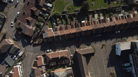 4K-aerial-view-of-a-residencial-area-in-taunton-Somerset,-United-Kingdom,-drone-rotating-to-the-left-showing-the-buildings-roofs-and-the-streets