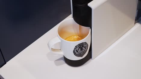 Closeup-making-coffee-from-a-capsule-in-an-automated-Nespresso-machine