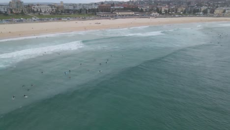 Surfers-On-Perfect-Sea-Waves-During-Holiday-Adventure---Bondi-Beach-In-Eastern-Suburbs,-Sydney,-New-South-Wales,-Australia
