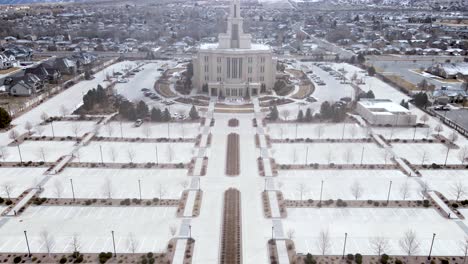 Empty-Parking-Lot-In-Front-Of-Payson-Utah-Temple,-Church-of-Jesus-Christ-of-Latter-day-Saints-With-Snowy-Mountain-At-Wintertime-In-Payson,-Utah,-USA