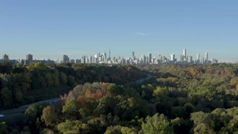 The-skyline-of-Toronto,-Canada-in-the-distance-with-never-ending-forest-in-front-of-it