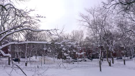 Drone-flying-in-a-residential-neighbourhood-in-a-snow-covered-public-park