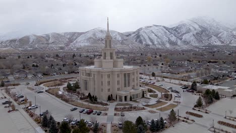 LDS-Mormon-Payson-Temple-on-Cloudy,-Snowy-Day-in-Utah---Aerial