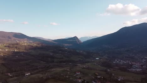 Aerial-landscape-view-over-italian-mountain-villages,-on-a-sunny-evening