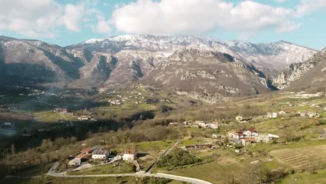 Aerial-landscape-view-above-italian-mountain-villages,-on-a-sunny-day