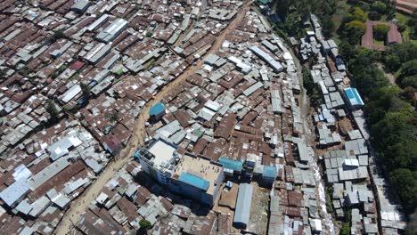Aerial-view-over-people-playing-on-a-rooftop-in-Kibera,-largest-slum-in-Africa