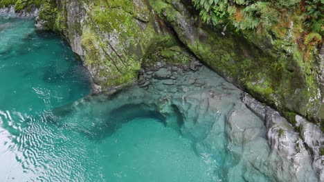 Crystal-clear-river-water-reveals-sculpted-limestone-below-the-surface
