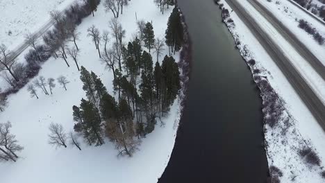AERIAL---A-river-splits-and-the-camera-tilts-up-revealing-the-beautiful-scenery