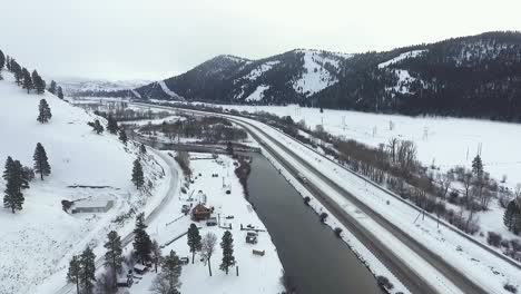 AERIAL---A-light-flurry-hits-the-river-along-the-highway