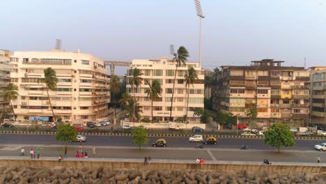 Drone-shots-of-the-most-iconic-walkway-of-South-Bombay,-Marine-Drive,-also-known-as-The-Queen's-Necklace-as-seen-before-The-Great-Mumbai-Coastal-Road-is-made