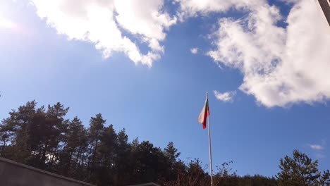The-Bulgarian-flag-is-waving-on-a-high-pole-surrounded-by-trees