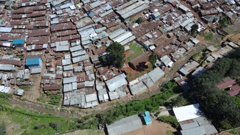 Aerial-shot-looking-straight-down-above-vast-overpopulated-slums-in-Kibera,-Nairobi,-Kenya,-Africa