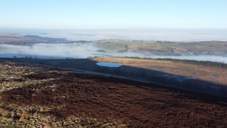 Lancashire-farming-countryside-aerial-cloudy-misty-valley-moorland-hillside-orbit-left-across-landscape