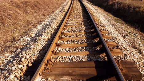 Tilt-up-shot-between-rails-on-an-empty-railroad-in-the-middle-of-nowhere
