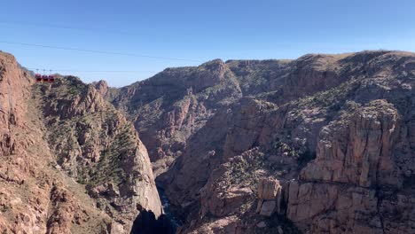 View-of-Royal-Gorge-red-rocks-and-aerial-gondola-ride-over-canyon-with-blue-sky