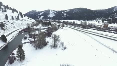 AERIAL---a-light-snow-hits-the-travelers-on-the-beautiful-interstate