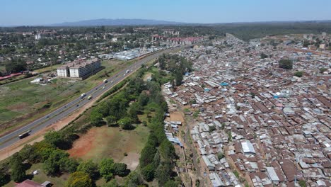 Aerial-view-over-Kibera-rusted-metal-rooftops,-largest-slum-in-Africa