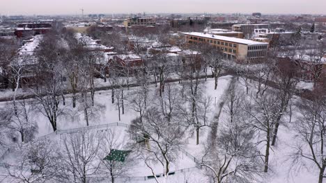 Drone-shot-over-a-public-park-in-a-residential-neighbourhood-in-Montreal's-winter