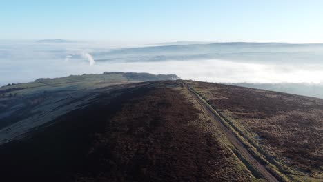 Cloudy-misty-sunrise-valley-aerial-moorland-hiking-hillside-muddy-path-Lancashire-forward-left-orbit