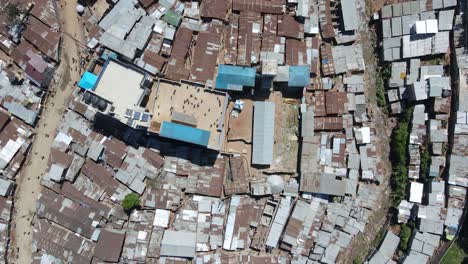Aerial-view-of-people-playing-on-a-rooftop-in-Kibera,-largest-slum-in-Africa