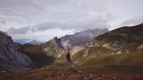 Woman-is-hikeing-in-the-Alps---Fast-Parallax-drone-flight