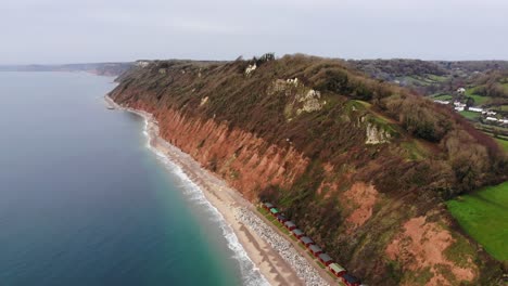 Aerial-shot-of-the-Cliffs-at-Branscombe-highlighting-the-Beautiful-calm-sea-of-Lyme-Bay-Devon-England-UK