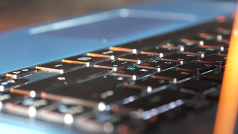 Portable-laptop-computer-keyboard-in-close-up-panning-view-in-office