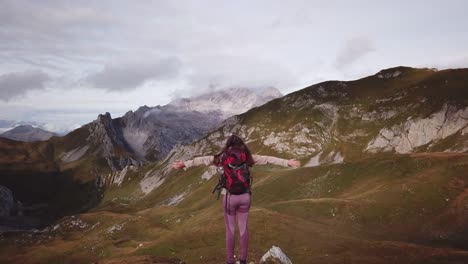 Woman-is-standing-in-the-Alps---Fast-reverse-Parallax-drone-flight