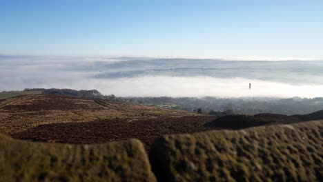 Industry-chimney-through-fog-clouds-passing-countryside-valley-stone-tower-viewpoint-dolly-right