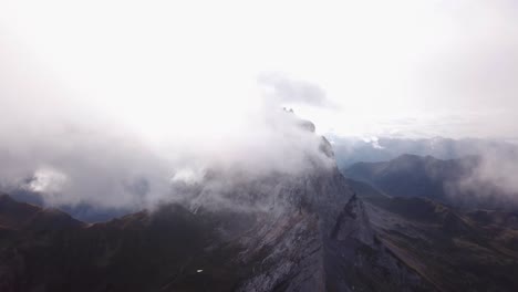 Drone-flight-by-clouds-Alps-in-Austria-Vorarlberg-over-reservoir-Lake