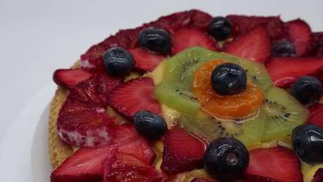 Fresh-fruit-tart-with-strawberries,-kiwi-and-orange,-isolated-on-white-background