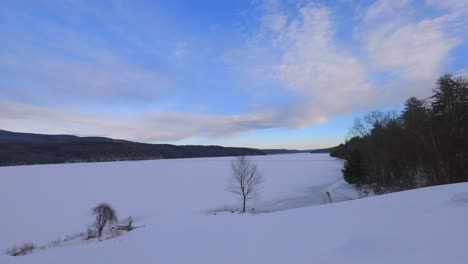 Cloud-time-lapse-over-a-frozen,-snowy-mountain-lake-in-the-appalachian-mountains-in-America-in-new-york-in-the-hudson-valley-in-the-catskill-mountains-during-winter