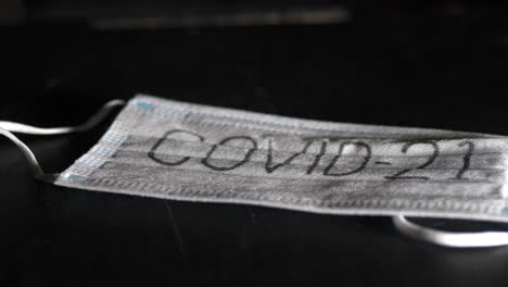 Mask-with-Text-Covid-19,-Protection-Against-Corona-Virus-Outbreak,-Close-Up