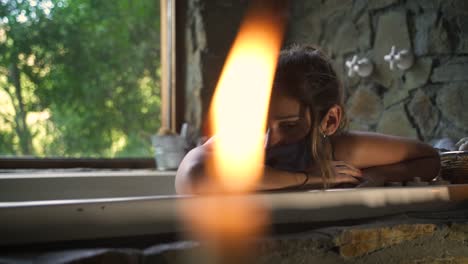 Young-attractive-female-having-a-fancy-bath-in-a-jacuzzi-worried-sad-with-covid-mask-with-big-green-nature-window-able-to-slow-motion-60fps-3