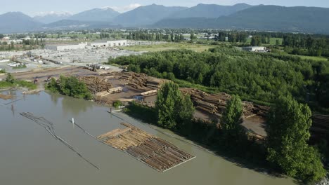 Drone-shot-of-a-river-bank-lumber-processing-plant