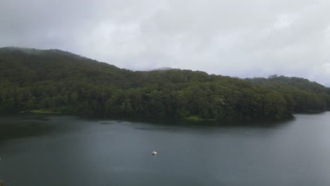 Drone-Reveal-Of-Calm-Water-At-Karangi-Dam-In-An-Overcast-Weather