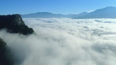 Drone-overview-of-an-impressive-sea-of-clouds-in-high-mountain-with-blue-sky