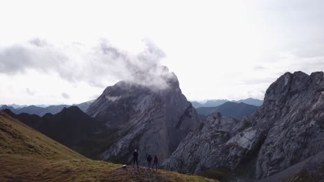 Three-people-are-hikeing-in-Alps---Drone-flight-over-some-people-in-Alps