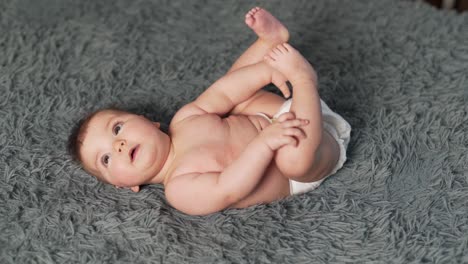top-view-of-baby-girl-lying-on-her-back-and-looking-around