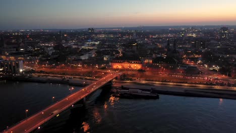 Leaving-Mainz-by-night-with-a-drone-at-magic-hour-over-the-Rhine-river-and-the-old-bridge