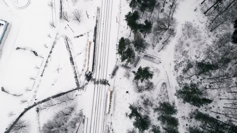 Aerial-top-down-view-over-snow-covered-land-at-countryside-village-during-extreme-winters