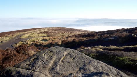 Rotating-fog-clouds-passing-farmland-moorland-countryside-valley-highlands-viewpoint-dolly-right